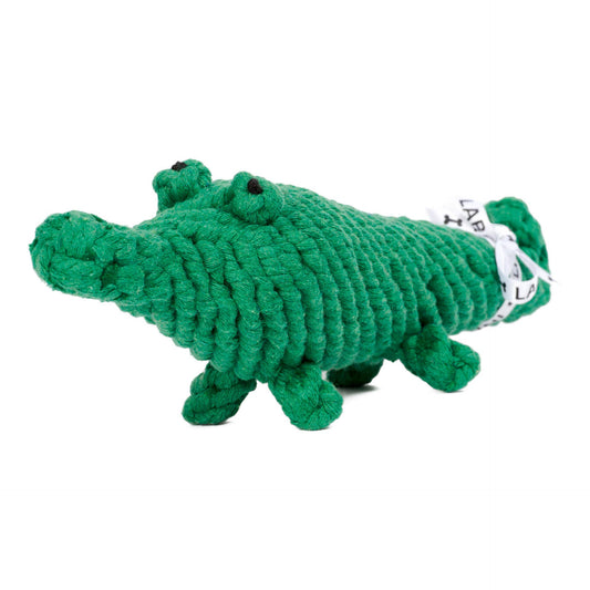 A green crocodile-shaped dog toy made of thick, chunky cotton knotted rope, Kalli Krokodil dog toy, hand-braided cotton for tartar reduction shown on a plain white background.